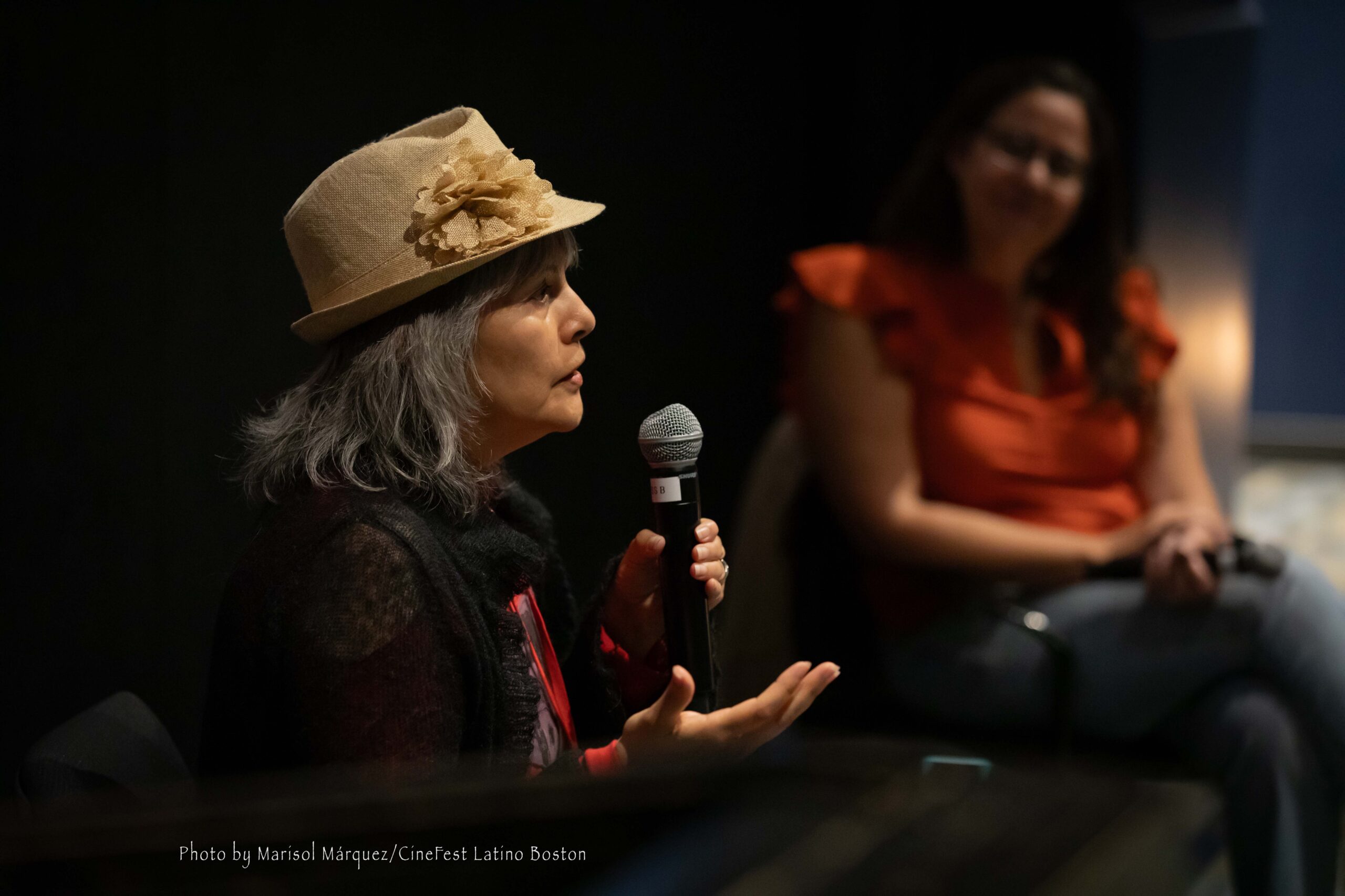 Mabel-Boston-435A1153-credit-final Close-up of director Mabel Valdiviezo speaking into a microphone during a Q&A session in San Francisco.